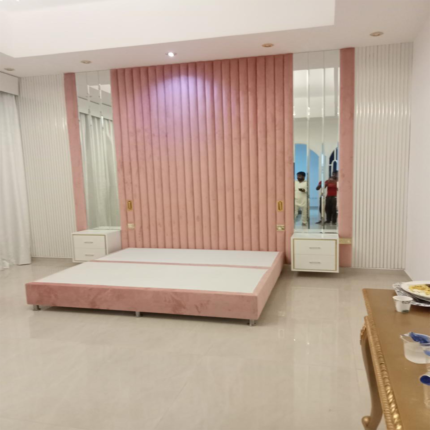 Discover a modern upholstered bed with a tall vertical panel headboard.